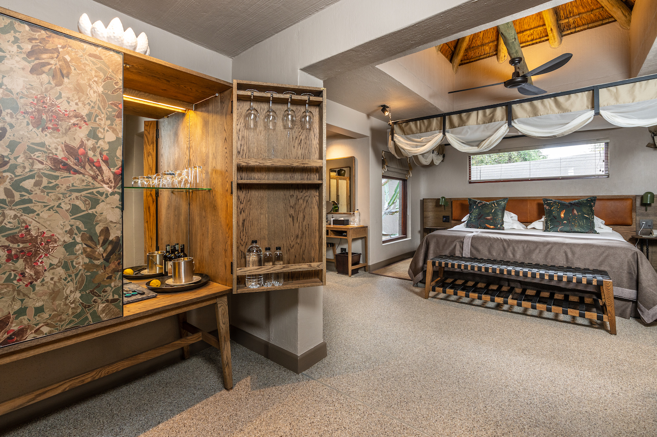 <p>The Suites at Sabi Sabi Bush Lodge are spacious and beautifully decorated with African-inspired furnishings and decor. Each room is equipped with modern amenities, including air conditioning, ceiling fans, and en-suite bathrooms with both indoor and outdoor showers.</p>  <p>The rooms also feature private decks with stunning views of the surrounding bushveld, providing guests with the opportunity to spot wildlife from the comfort of their own room.</p>  <p>Overall, the bedrooms at Sabi Sabi Bush Lodge offer a luxurious and unforgettable safari experience.</p>